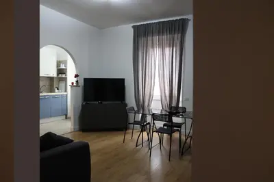 a living room with a table and chairs and a television at IN love with rome gemelli e vaticano in Rome
