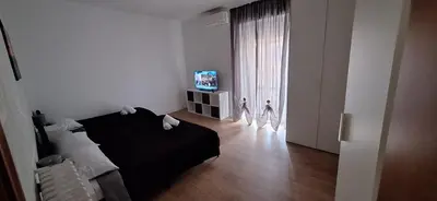 a bedroom with a black bed and a television at IN love with rome gemelli e vaticano in Rome