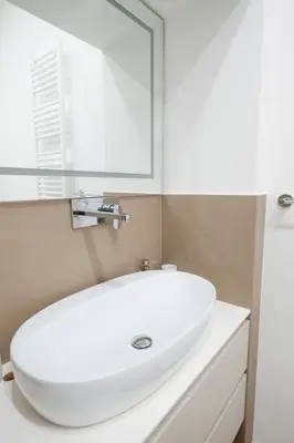 a bathroom with a white sink and a mirror at Stunning 1BR, 2BATH Apartment in the Heart of Rome 6C in Rome