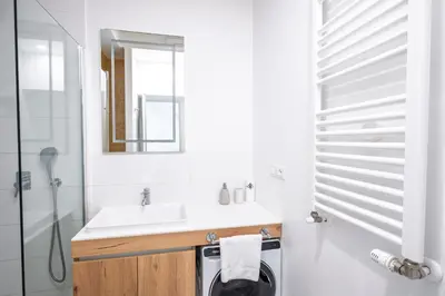 a bathroom with a sink and a washing machine at Charming Vatican Apartment with Balcony 6B in Rome