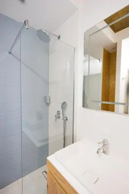 a bathroom with a glass shower and a sink at Charming Vatican Apartment with Balcony 6B in Rome
