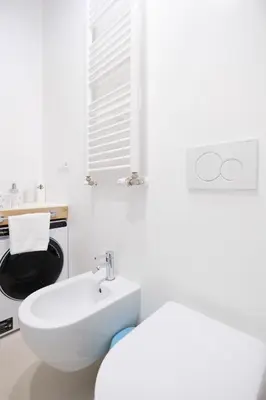 a white bathroom with a sink and a toilet at Charming Vatican Apartment with Balcony 6B in Rome