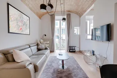 a living room with a couch and a table at Charming Vatican Apartment with Balcony 6B in Rome