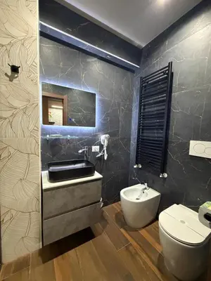 a bathroom with a white toilet and a sink at La Dimora del Re in Rome