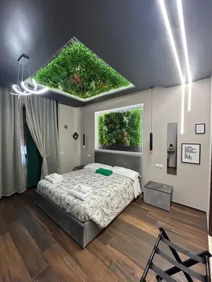 a bedroom with a bed with a green roof at La Dimora del Re in Rome