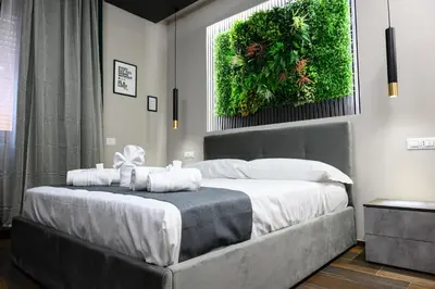 a bedroom with a large bed with a green wall at La Dimora del Re in Rome