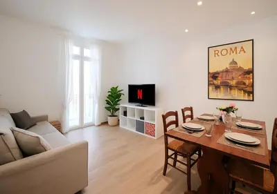 a living room with a table and a couch at COLOSSEO a 15 min - Attico con Terrazza in Rome