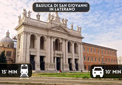 a large building with two cars parked in front of it at COLOSSEO a 15 min - Attico con Terrazza in Rome