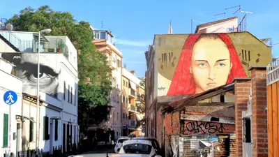 a mural of a woman on the side of a building at COLOSSEO a 15 min - Attico con Terrazza in Rome