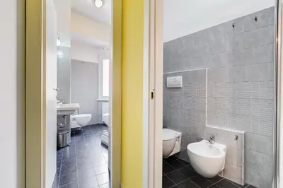 a bathroom with a white toilet and a sink at BDC - Kingdom 5-BDR in Termini in Rome