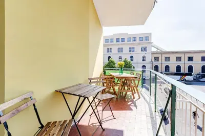 a balcony with tables and chairs and a building at BDC - Kingdom 5-BDR in Termini in Rome