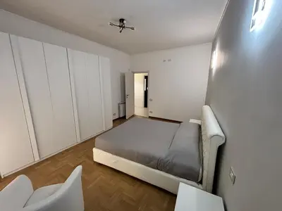 a bedroom with a bed and white cabinets at Luca's House - Your perfect Roman hideaway in Rome