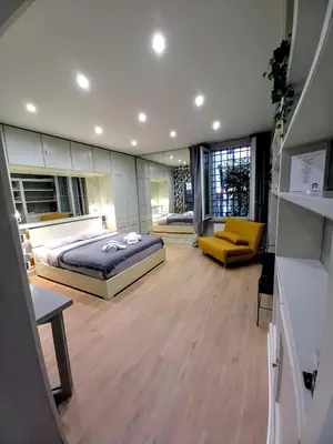 a large bedroom with a bed and a yellow couch at Piazza di Spagna, ground floor, historic center in Rome