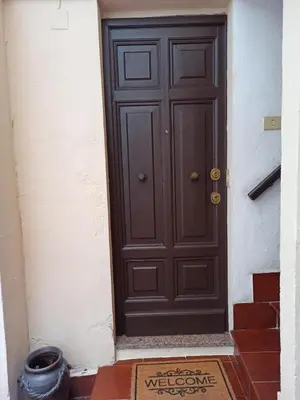 a brown door with a welcome sign in front of it at Piazza di Spagna, ground floor, historic center in Rome