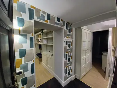 a hallway with a wall covered in colorful tiles at Piazza di Spagna, ground floor, historic center in Rome