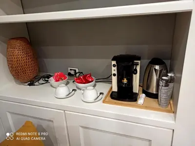 a coffee maker and two cups on a counter at Piazza di Spagna, ground floor, historic center in Rome