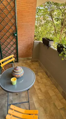 a table and two chairs on a patio at Joyful escape flat in Rome