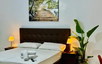 a bedroom with a bed with towels on it at Ayan Guest House in Rome