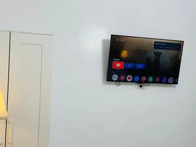 a flat screen tv hanging on a wall at Ayan Guest House in Rome