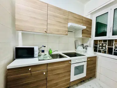 a kitchen with a sink and a microwave at Ayan Guest House in Rome