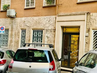 a car parked in front of a building with a door at Ayan Guest House in Rome