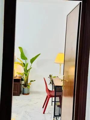 a room with a red chair and a table at Ayan Guest House in Rome