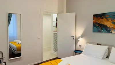 a bedroom with a bed and a mirror at Apartmentdigioia in Rome
