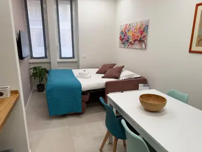 a small room with a bed and a couch at Apartmentdigioia in Rome