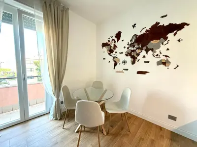 a dining room with a glass table and white chairs at Aurelia Luxury Rome in Rome