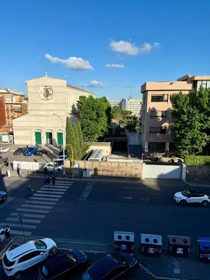 a parking lot with cars parked in front of a building at Aurelia Luxury Rome in Rome