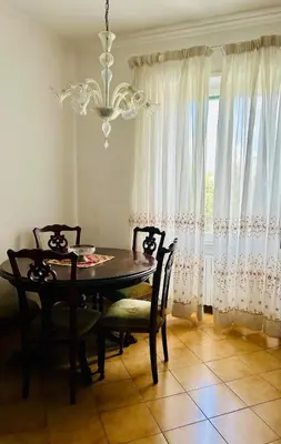 a dining room with a table and chairs and a chandelier at Casa San Pietro Rome Vatican in Rome