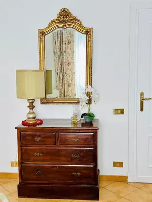 a dresser with a mirror and a lamp on it at Casa San Pietro Rome Vatican in Rome