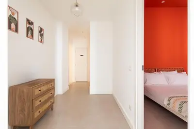 a bedroom with a bed and a wooden dresser at Glory House Trastevere 2 in Rome