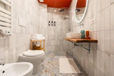 a bathroom with a toilet and a sink at Glory House Trastevere 2 in Rome