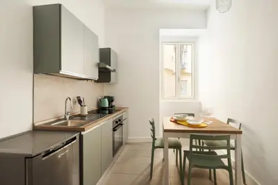 a small kitchen with a table and a sink at Glory House Trastevere 2 in Rome
