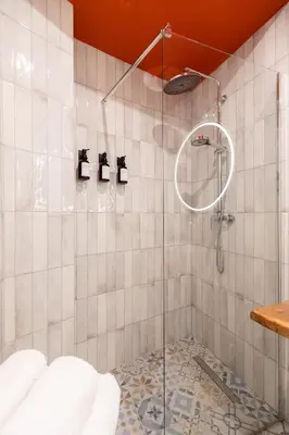 a shower with a glass door in a bathroom at Glory House Trastevere 2 in Rome