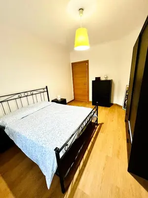 a bedroom with a bed and a television in it at Charming apartment Eur in Rome