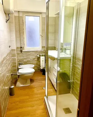 a small bathroom with a toilet and a window at Charming apartment Eur in Rome