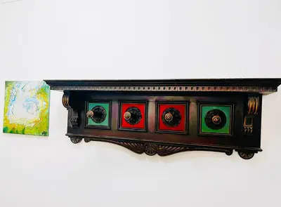 a wooden shelf with colorfulraphics on a wall at Charming apartment Eur in Rome