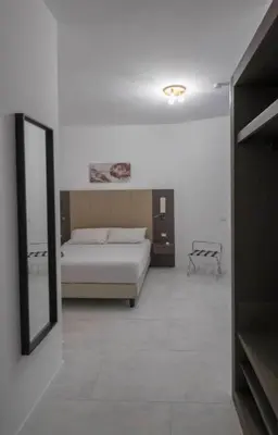 a bedroom with a bed and a mirror at Il Perugino Guest House in Rome