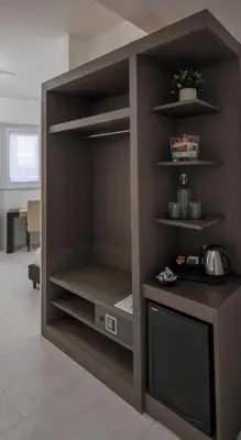 a cupboard with a television in a room at Il Perugino Guest House in Rome