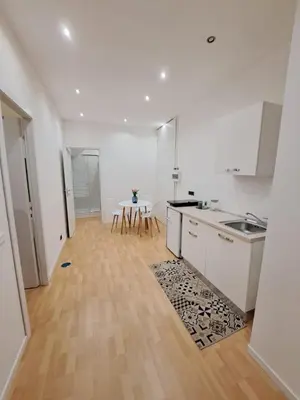 a kitchen with white counters and a table in it at TowerMorange in Rome