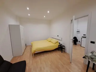 a bedroom with a bed with a yellow blanket at TowerMorange in Rome