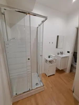 a shower stall in a bathroom with a sink at TowerMorange in Rome