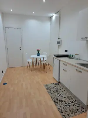 a kitchen with a table and a table and chairs at TowerMorange in Rome
