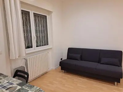 a living room with a couch and a window at TowerMorange in Rome