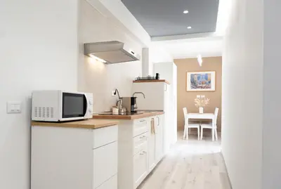 a white bathroom with a sink and a toilet at Domus Tiber in Rome