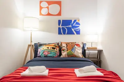 a bedroom with a bed with two towels on it at San Giovanni Metro A Cozy Suite WIFI AC in Rome