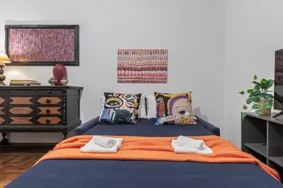 a bedroom with a blue bed with pillows at San Giovanni Metro A Cozy Suite WIFI AC in Rome