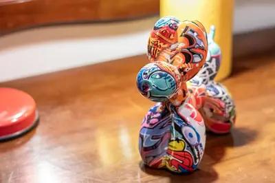 a small toy figurine of a monkey on a table at San Giovanni Metro A Cozy Suite WIFI AC in Rome